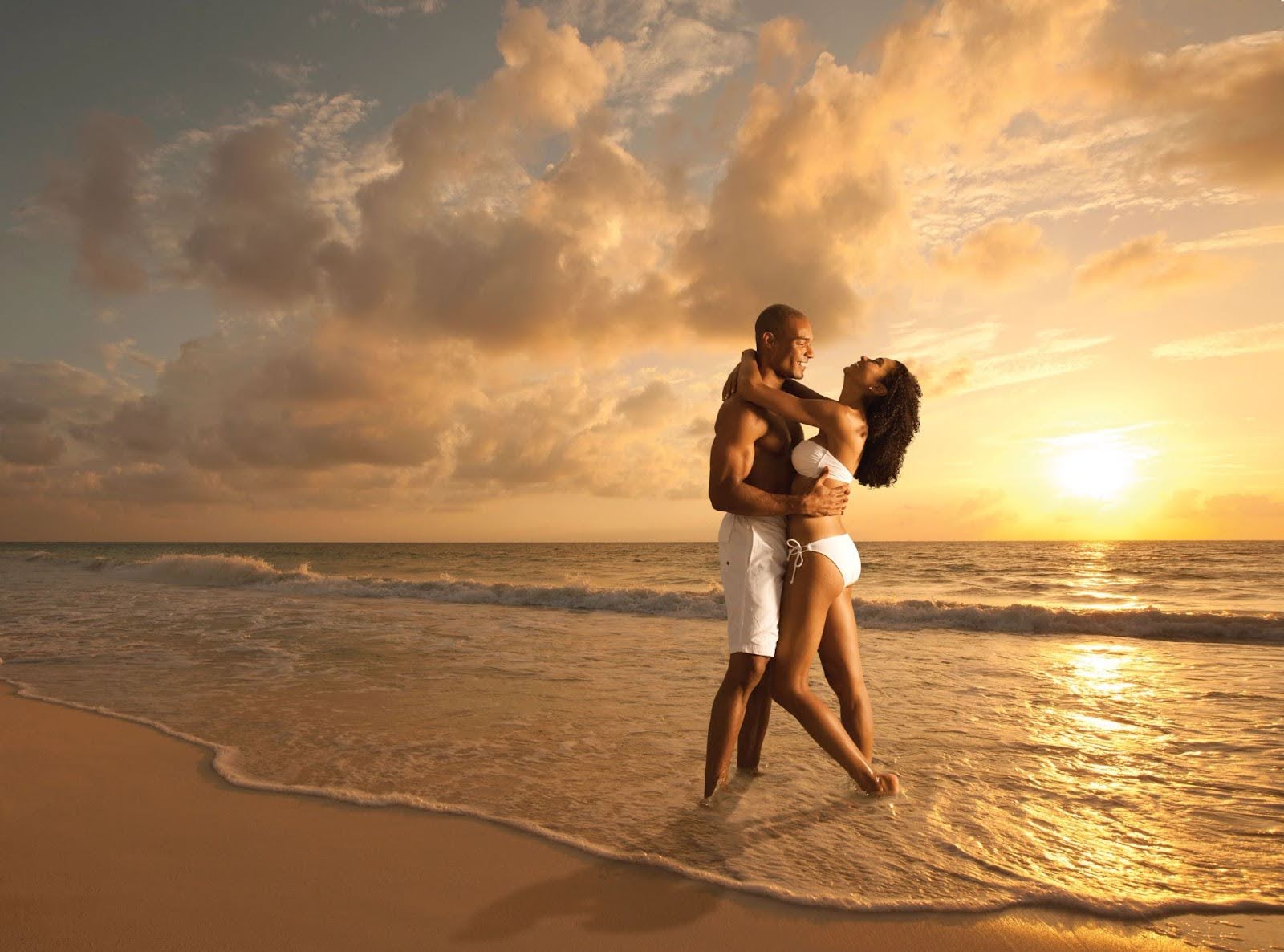 A couple enjoying a romantic sunset at the beach