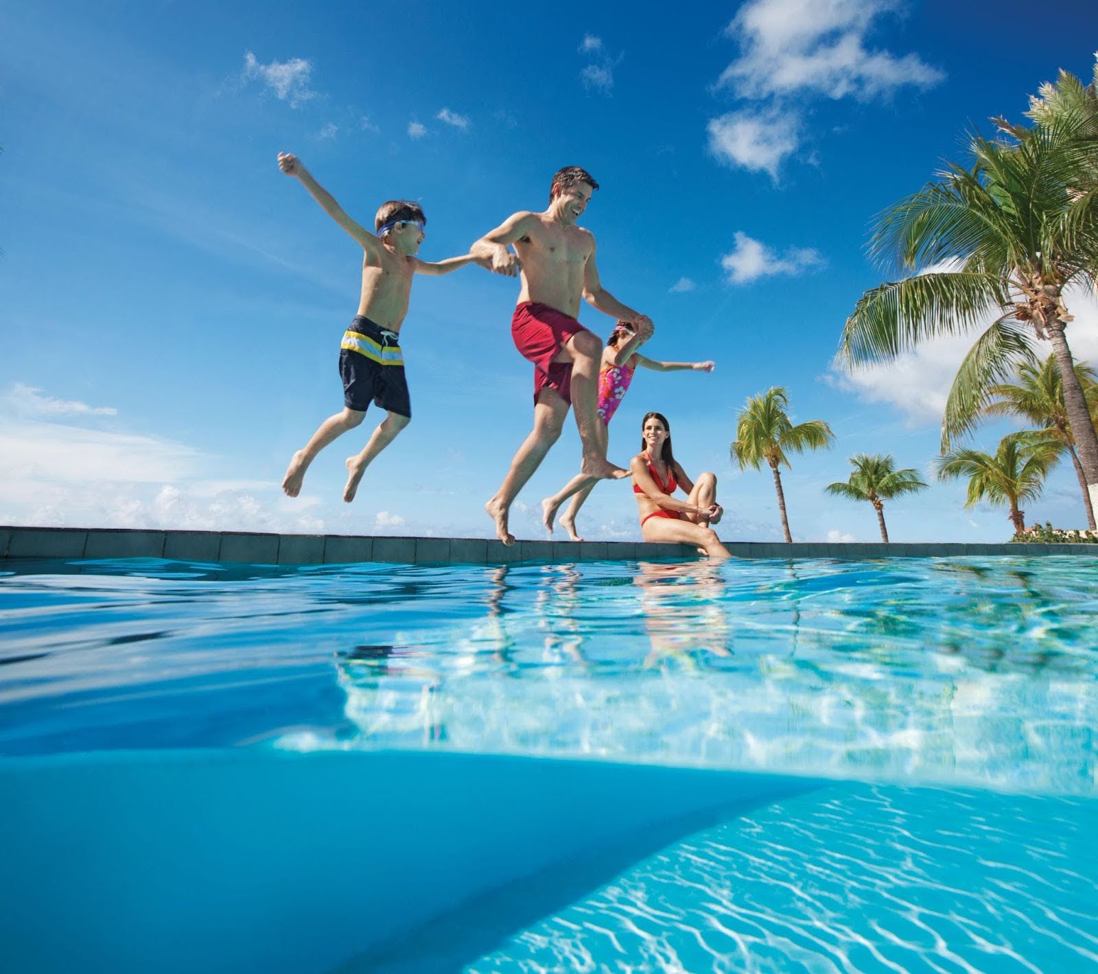 Family playing at the pool