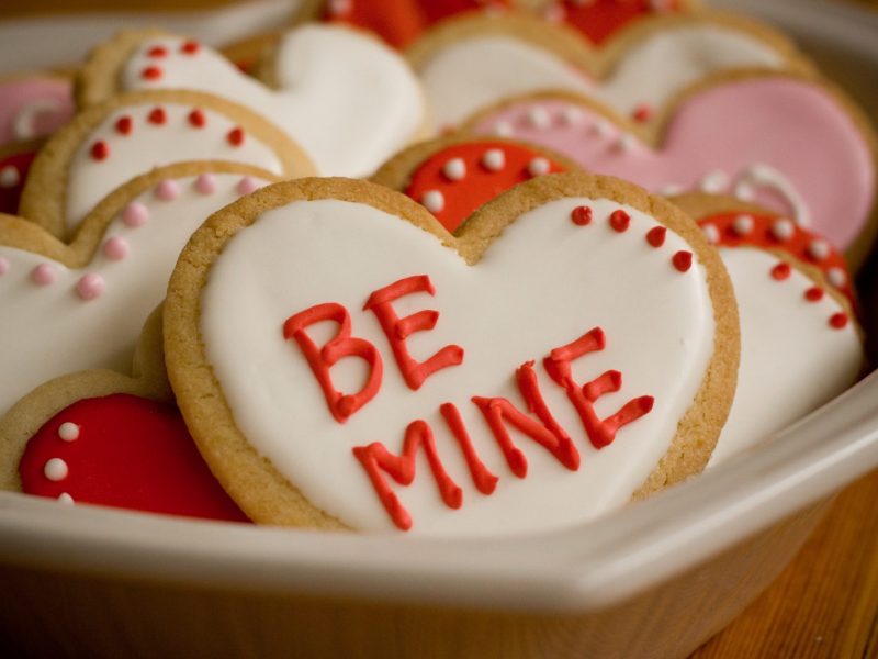 Valentine's Day Heart Shaped Cookies with red, white, and pink icing and messages of love.