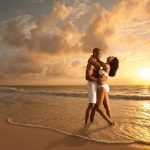 A couple enjoying a romantic sunset at the beach