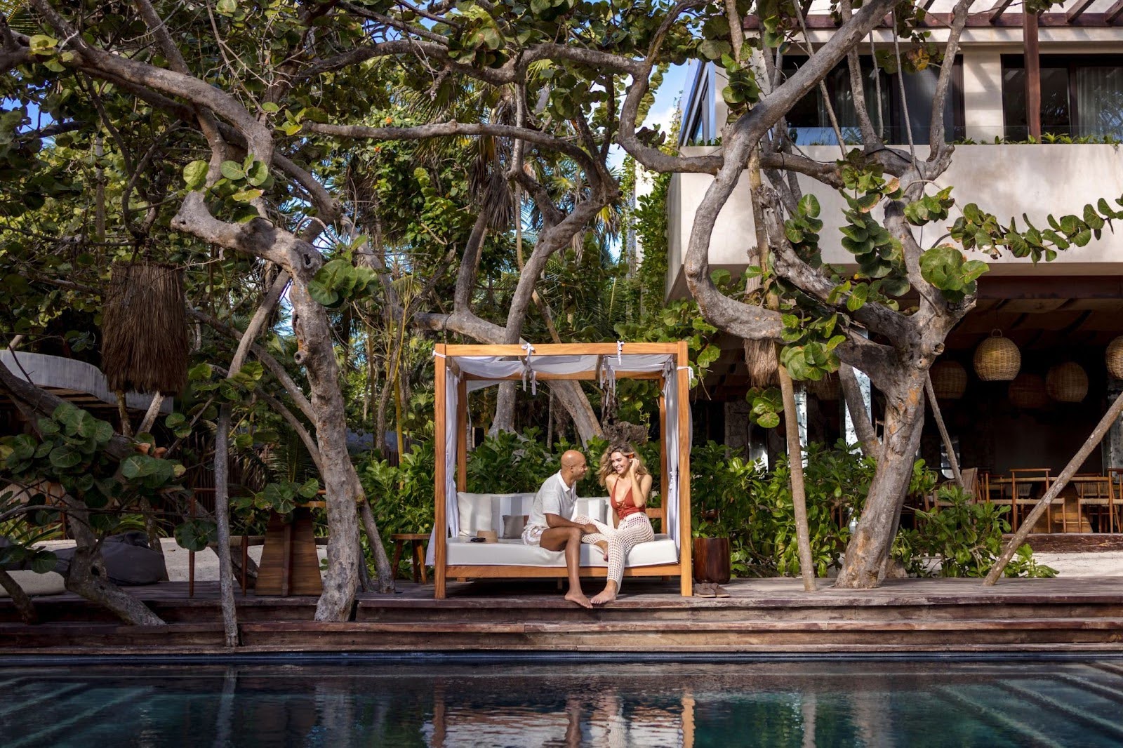 Couple at the beach club with big trees around them