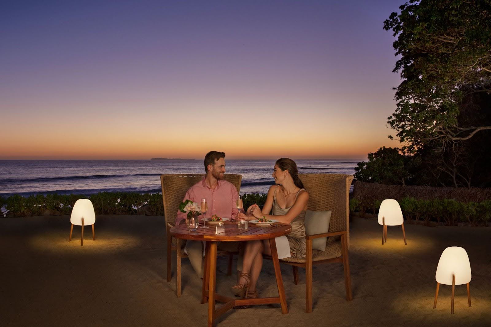 Couple having an intimate romantic dinner on the beach