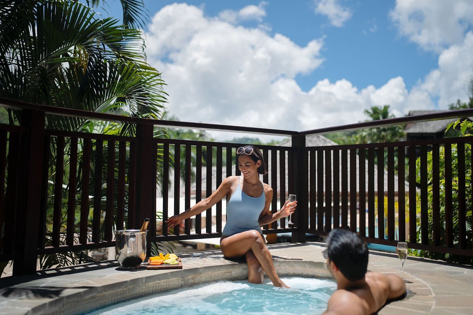 Couple relaxing and drinking at a private pool