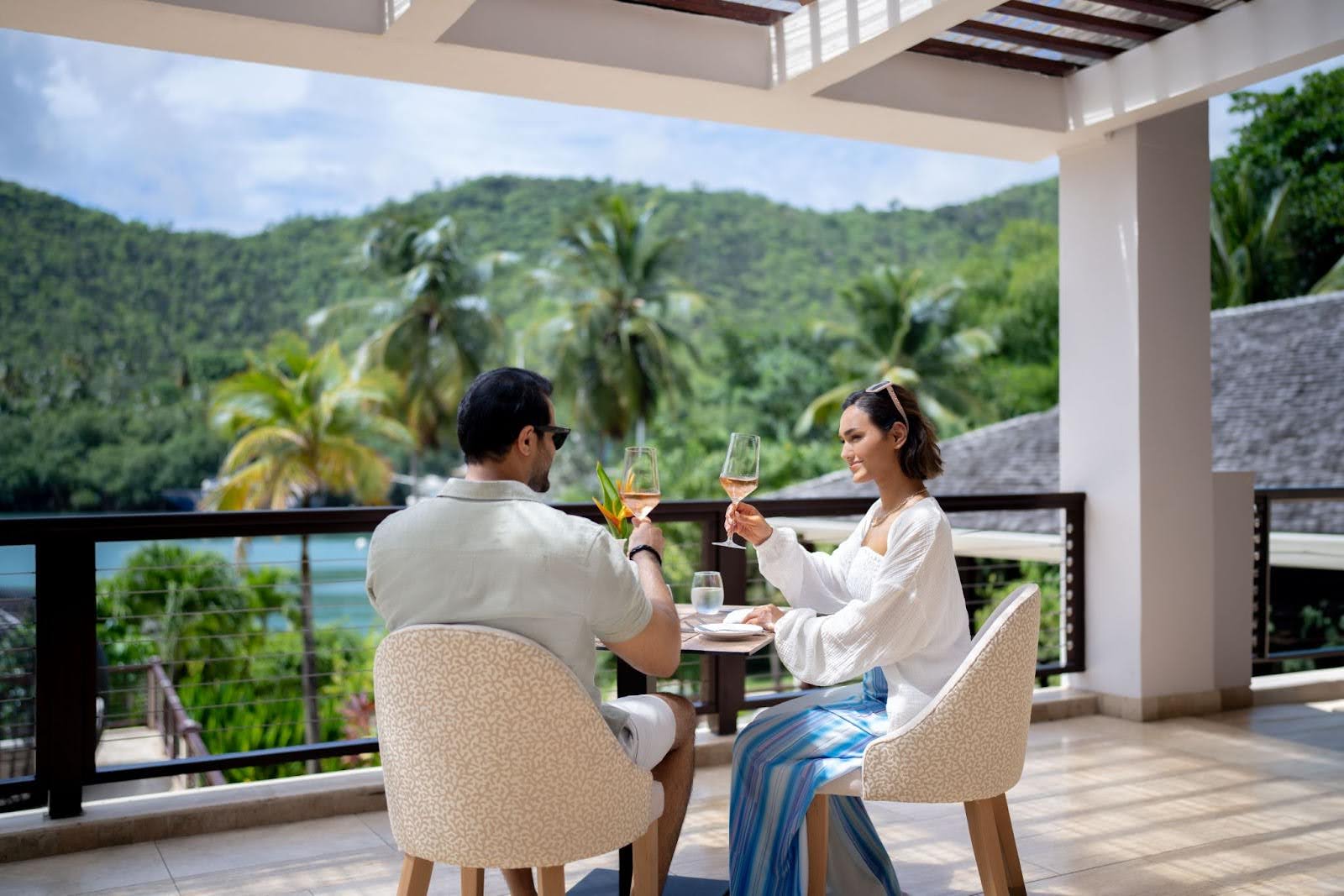 Couple toasting and eating with a beautiful view