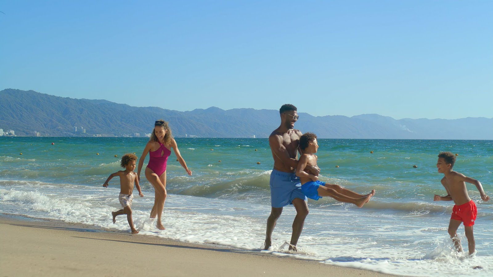 Family playing on the beach