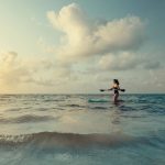Woman paddleboarding in the ocean