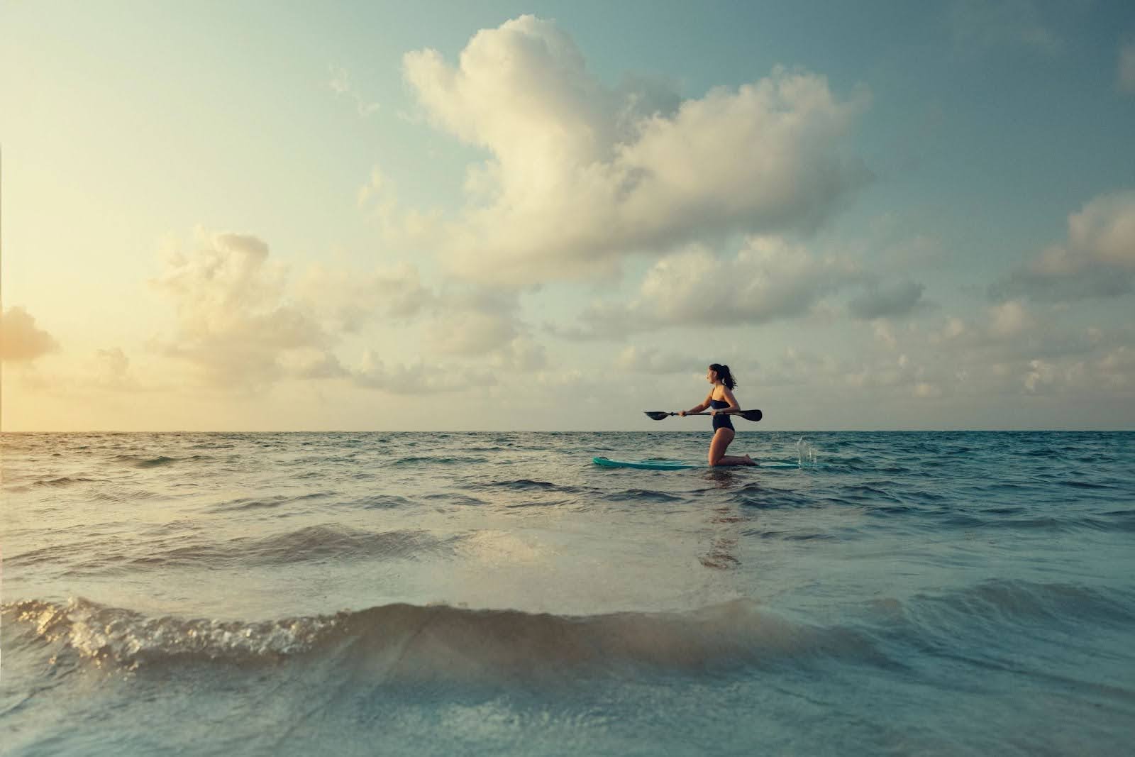 Woman paddleboarding in the ocean