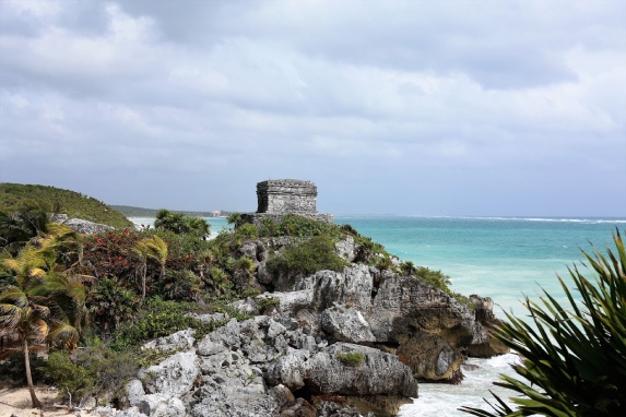 a view from historic ruins and a beach with crystalline water 