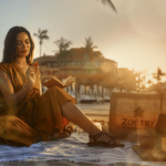 woman reading by the sea surrounded by natural elements and a zoetry bag zoetry casa del mar los cabos