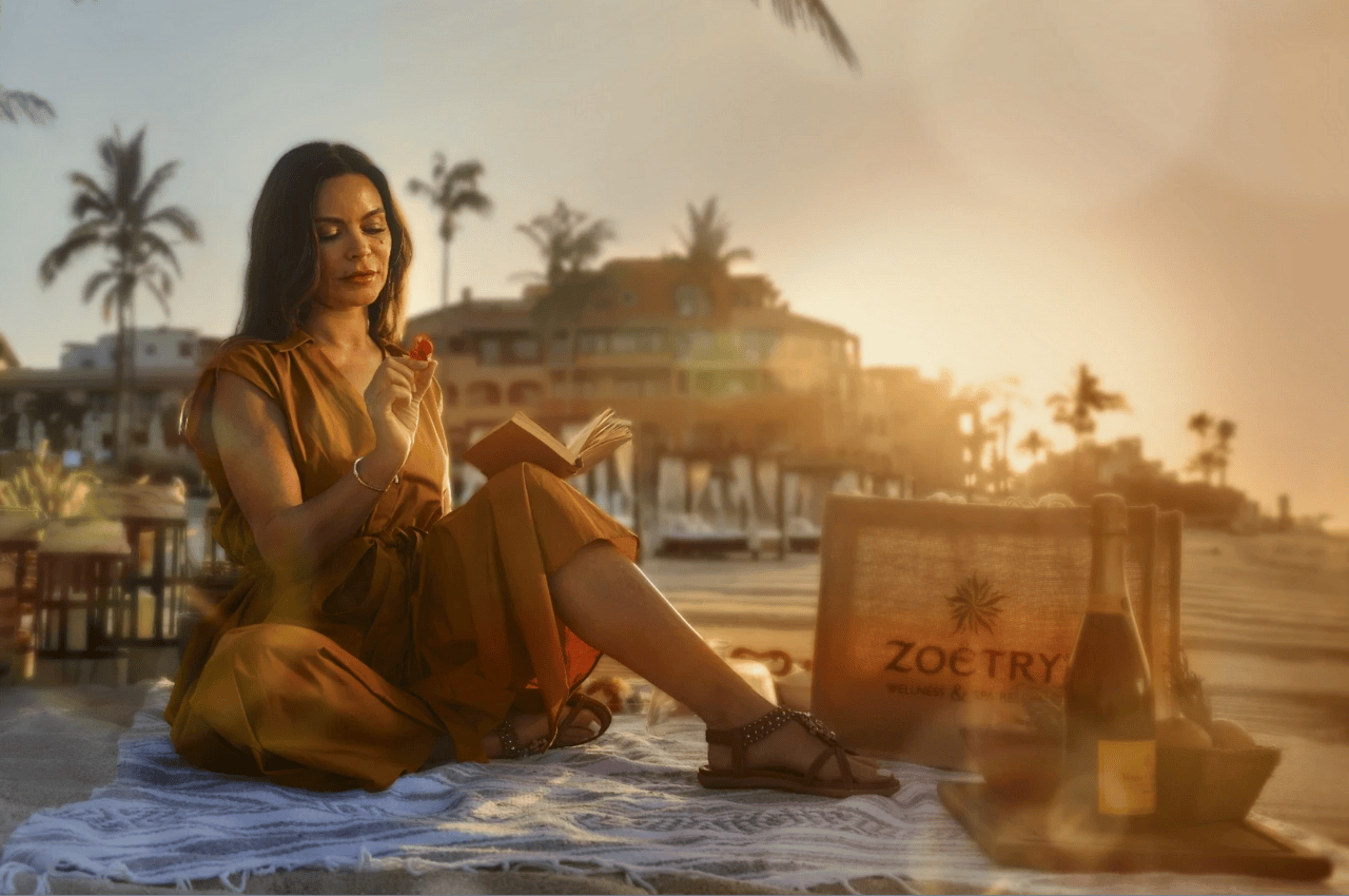 woman reading by the sea surrounded by natural elements and a zoetry bag zoetry casa del mar los cabos