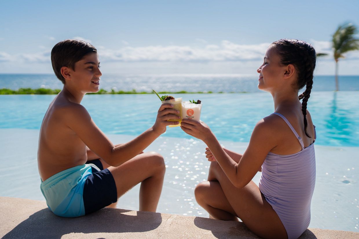Kids enjoying drinks by the pool